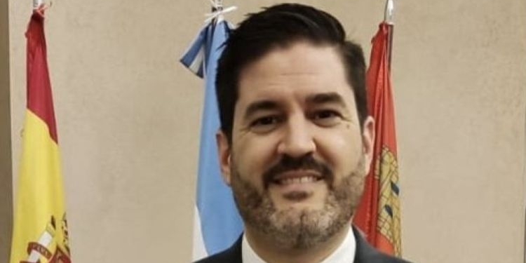 Juan Alvar Merino posando frente a banderas en su nuevo cargo