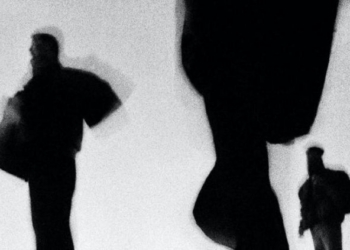 Fotografía en blanco y negro de personas en movimiento con abrigos